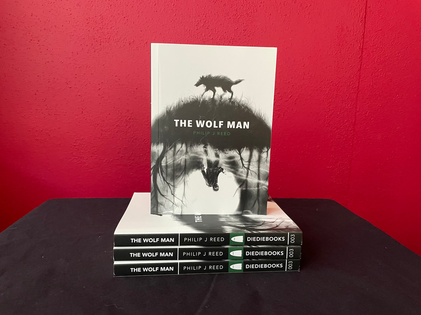Front and side view of the cover art and design for The Wolf Man by Philip J Reed