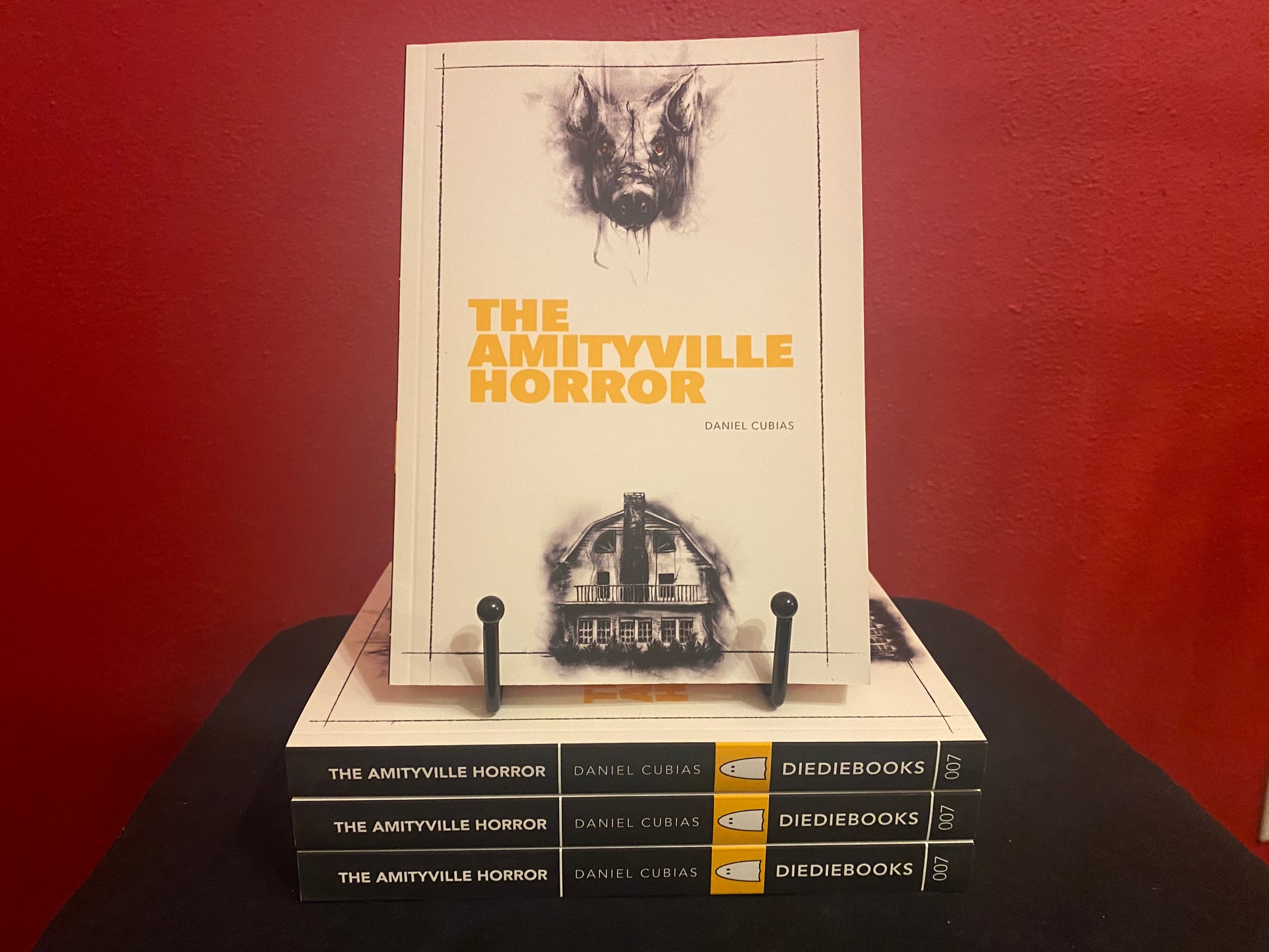 Stack of 'The Amityville Horror' DieDieBooks by author Daniel Cubias